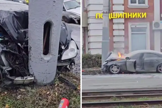 Mercedes в Омске столкнулся с другой машиной, отбросило в столб и авто загорелось. На месте работают пожарные и скорая; водитель жив.